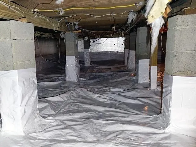 Crawl space encapsulation with vapor barrier installed on floor and foundation walls - NY Energy Project