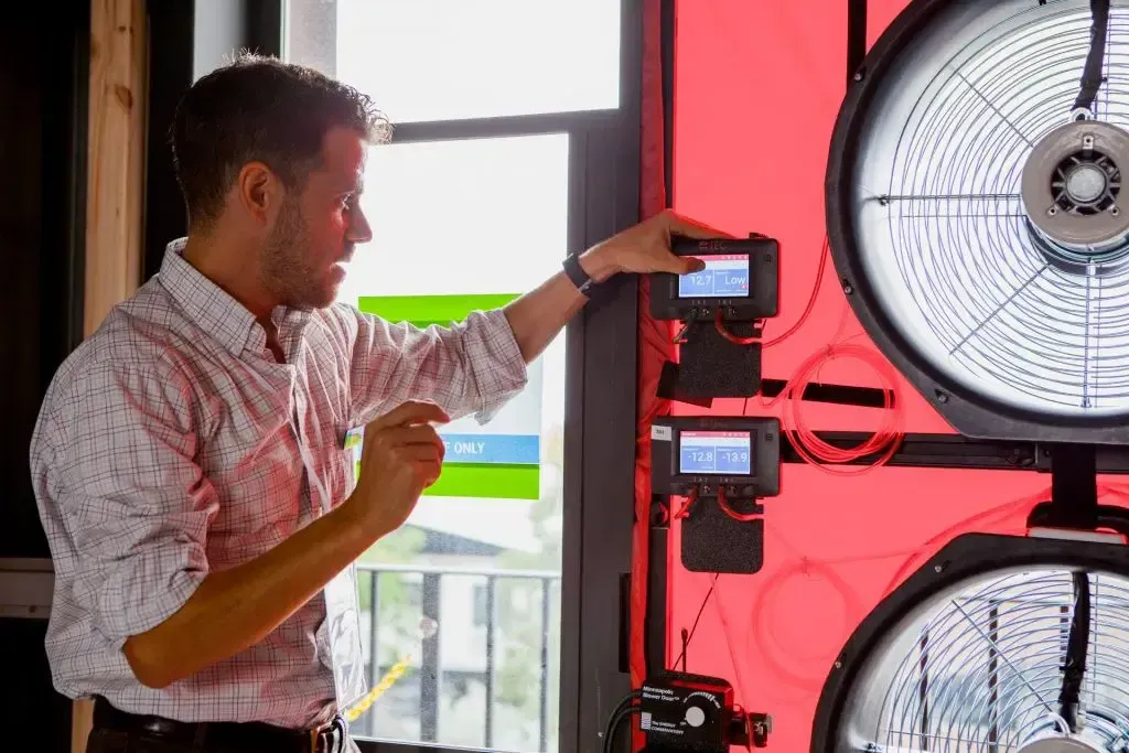 Blower door testing equipment installed in doorway