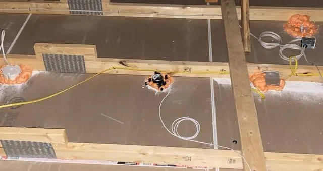 Recessed can lights sealed with spray foam to prevent air leaks