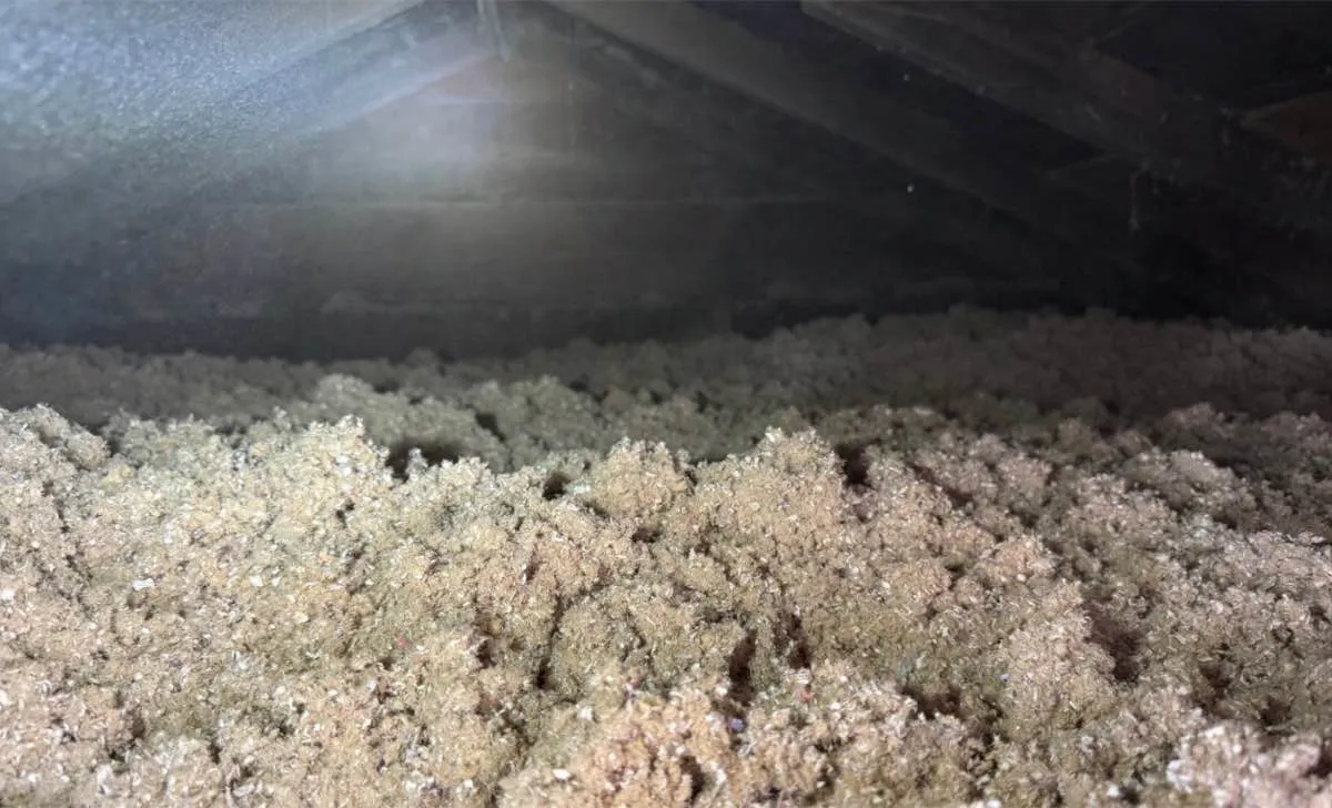 Close-up of attic insulation showing consistent coverage depth - NY Energy Project