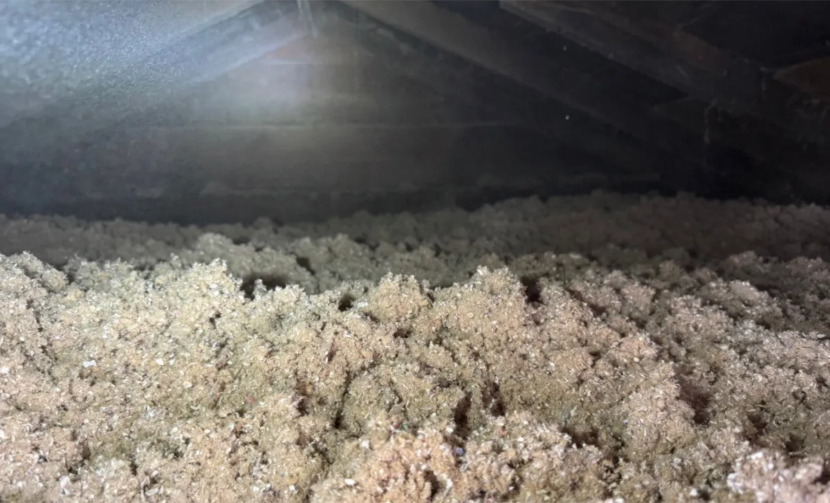 Close-up of attic insulation showing consistent coverage depth - NY Energy Project