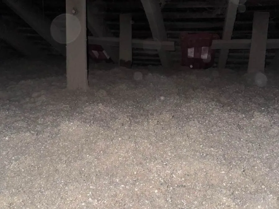 Blown-in cellulose insulation covering an attic floor - NY Energy Project job site