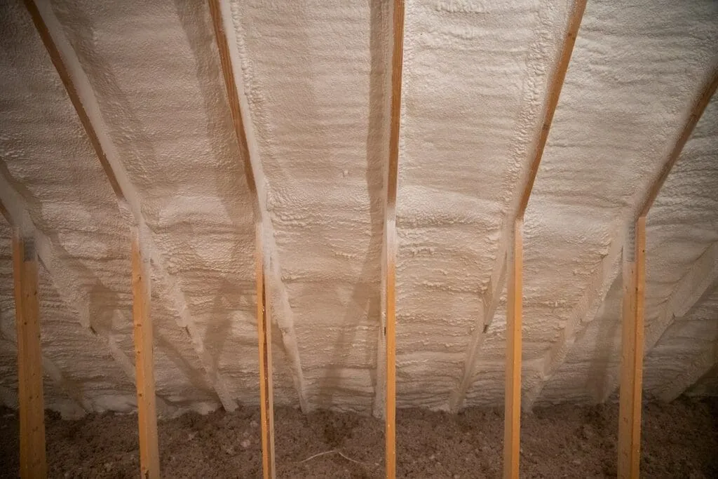 Closed-cell spray foam insulation installed between floor joists in a crawl space