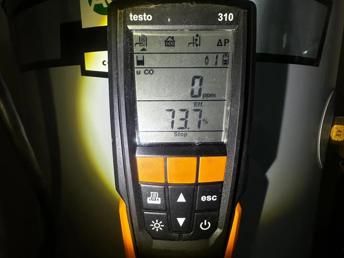 Testo 310 combustion analyzer testing water heater efficiency and CO levels during a Queens energy audit