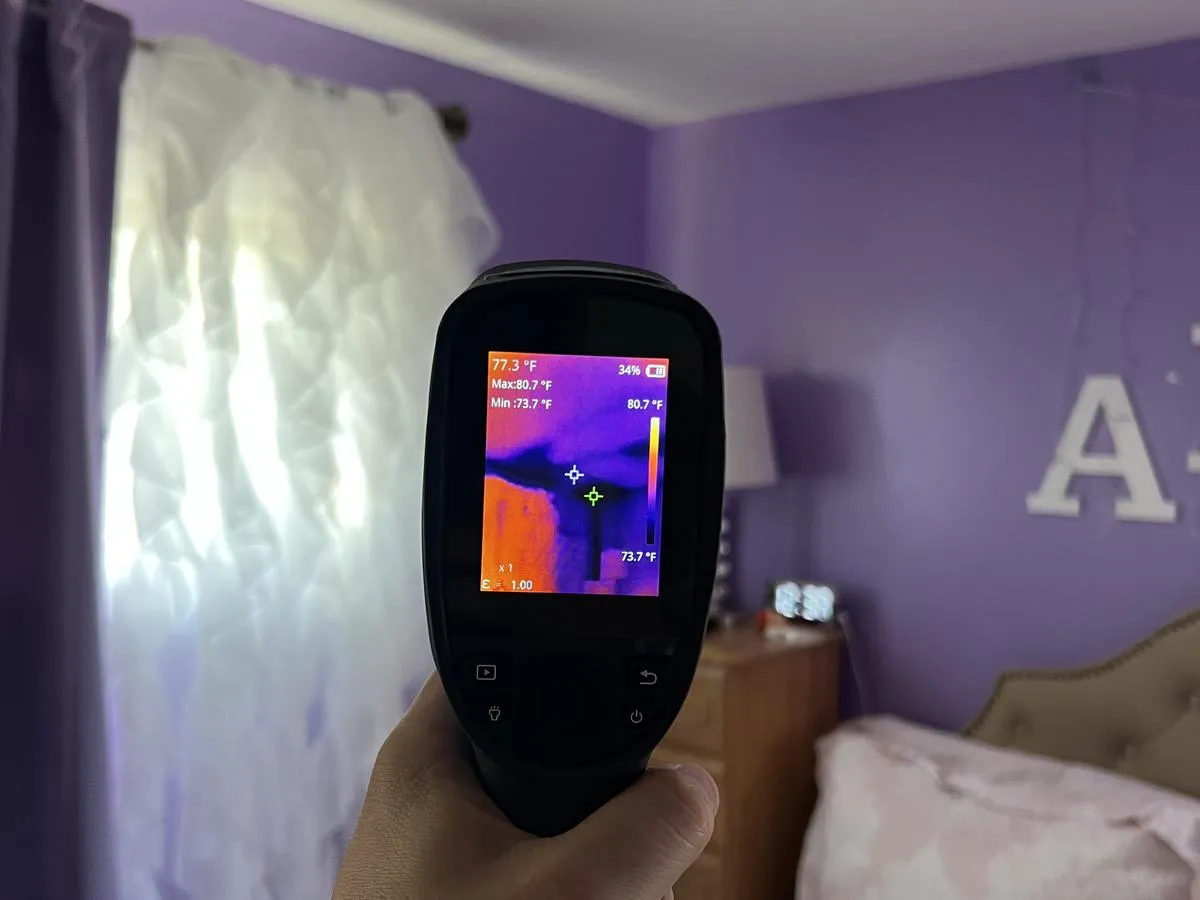 Thermal imaging camera scanning walls during a Brooklyn home energy audit