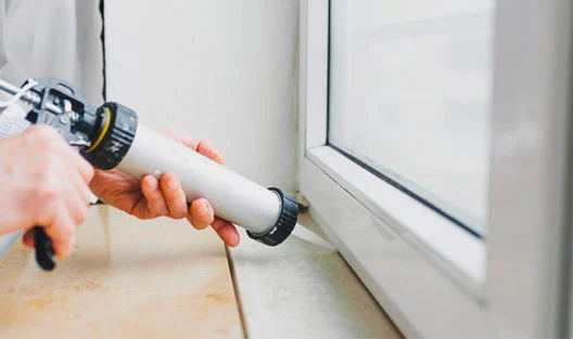 Detailed view of a home's windows, doors, and attic being air sealed with caulks, weatherstripping, and foam sealants